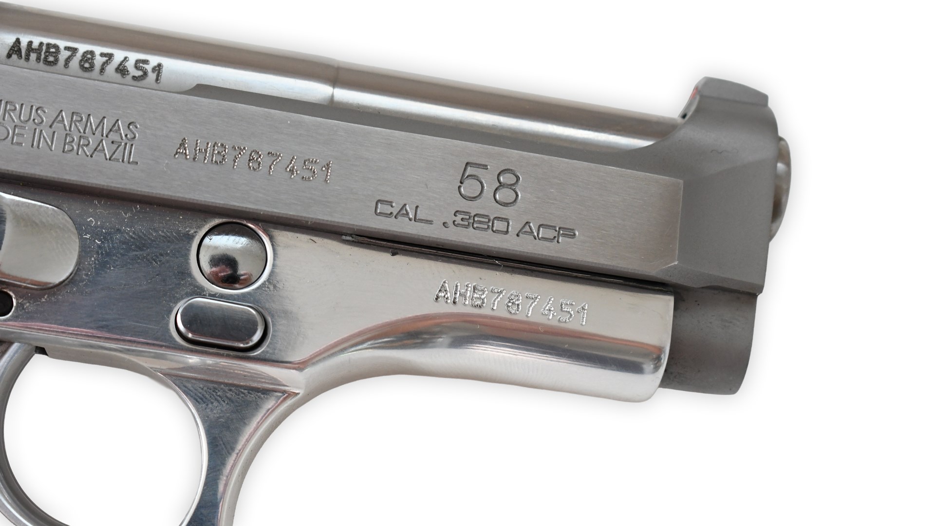 Taurus Model 58 handgun closeup right-side view slide markings stampings silver-finished metal on white background gun