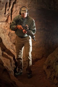 man with gun in a cave