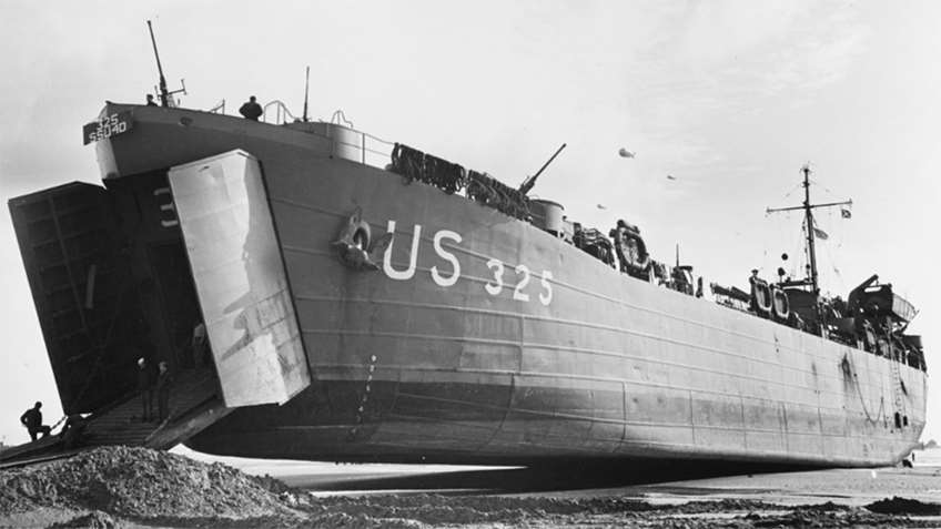 LST 325 out of the water at Normandy in June 1944, exposing the under-hull shape. LST 325 is a LST-1 class, like LST 393, and also still exists as a museum today.
