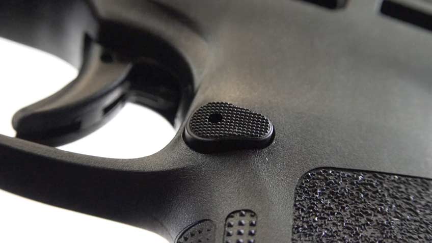 Black plastic pistol grip frame with button texturing and curves in plastic