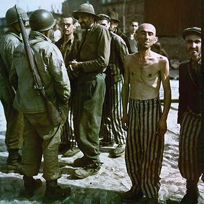 In this well-known photograph, U.S. Army soldiers – one of whom is armed with an M1903A3 rifle - talk to newly liberated prisoners of the concentration camp at Buchenwald near Weimar in Thuringia.