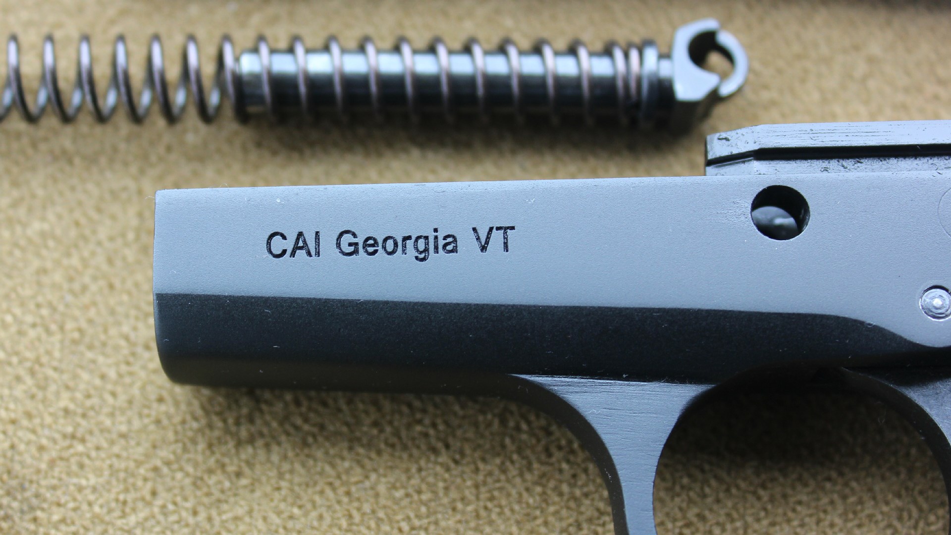Century Arms Centurion 14 frame closeup dustcover stamping "CAI GEORGIA VT" shown with recoil spring background
