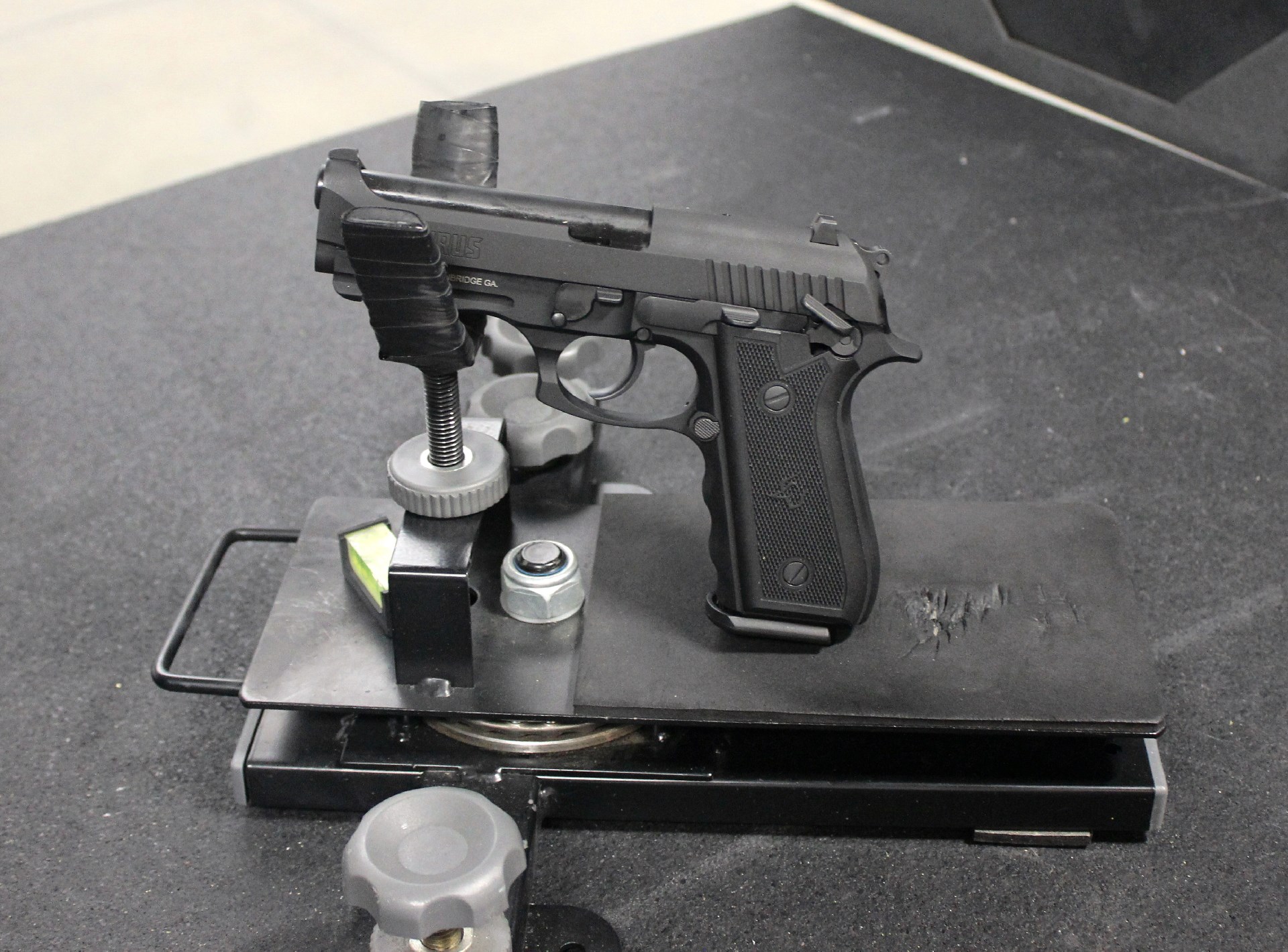 Taurus 917c pistol in cradle on shooting range