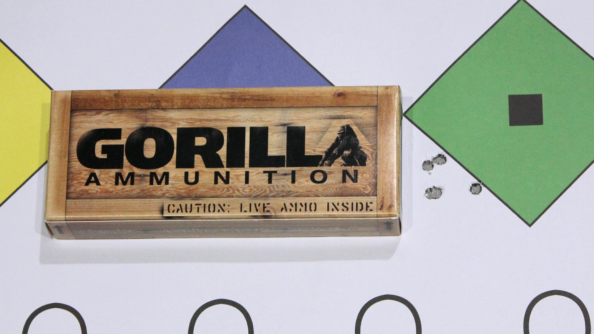 Gorilla Ammunition box shown on a colorful target with bullet holes accuracy group
