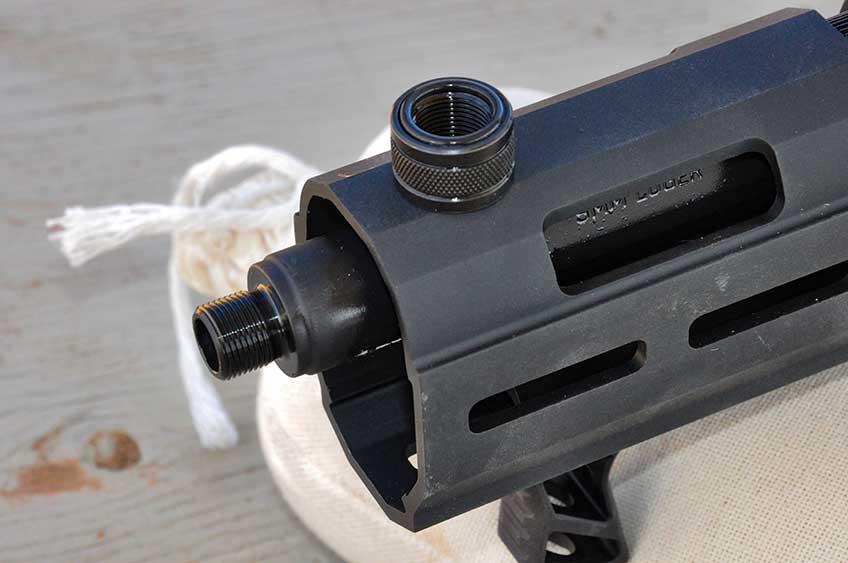 Muzzle of Ruger PC Charger pistol with thread protector removed and resting on handguard