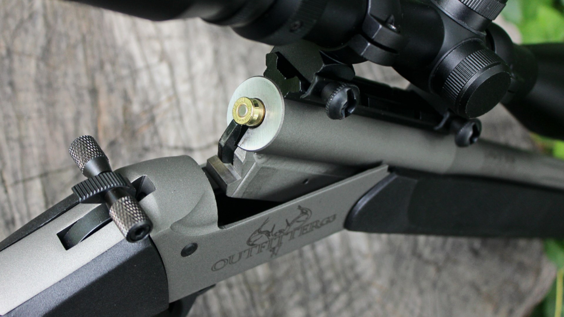 Traditions Outfitter G3 single-shot rifle action open closeup showing brass cartridge inserted into chamber