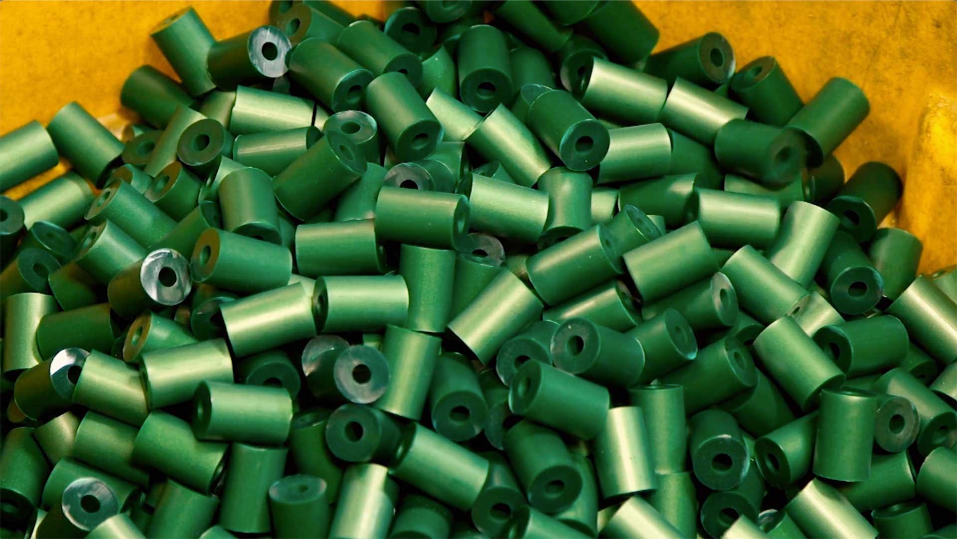 Green plastic extrusions waiting to be formed into shotshell hulls.