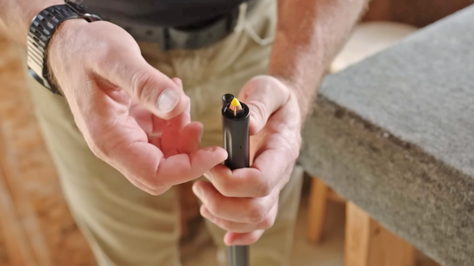 Man loading a Thompson/Center Arms Triumph in-line muzzleloader.