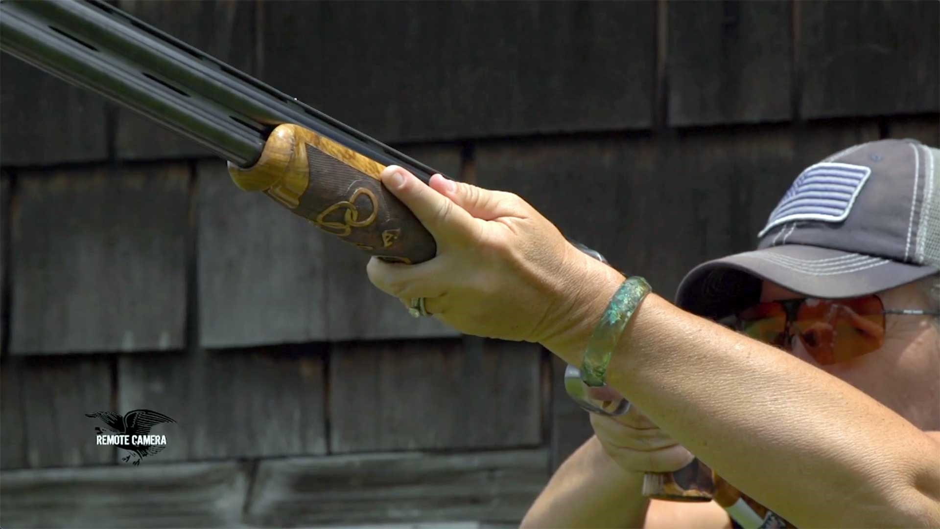 Kim Rhode's support hand on the fore-end of a shotgun.