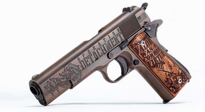 Left-side view on white background of Iwo Jima 1911 pistol with engravings of &quot;Operation Detachment&quot; and imagary.