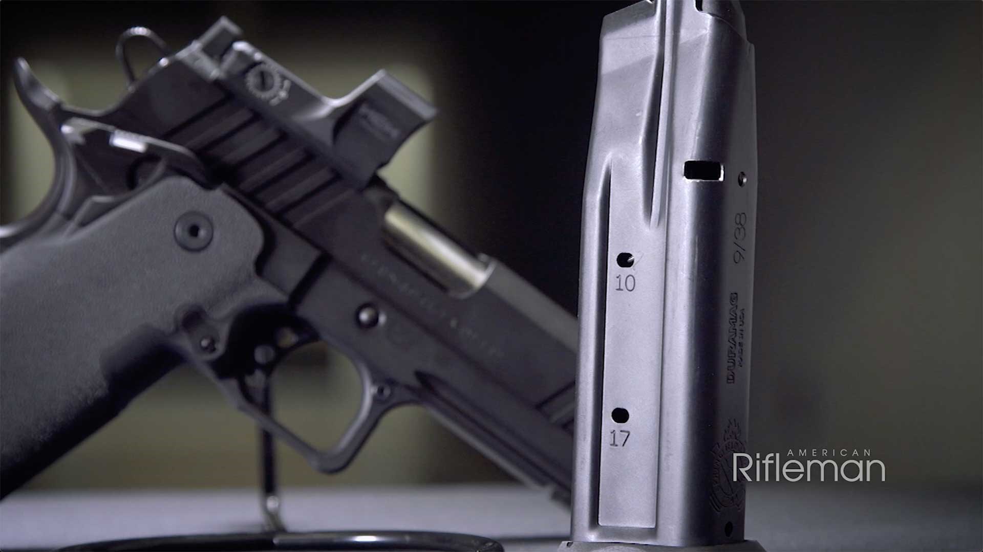 Double-stack, 17-round magazine standing up in front of the Springfield Armory Prodigy pistol.