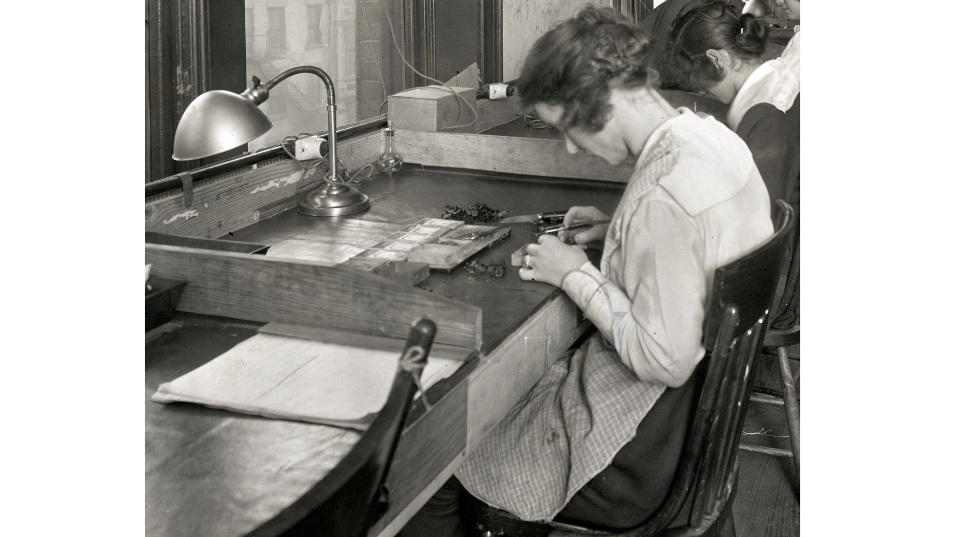 1918 photograph of lady painting sights desk chair sitting apron lamp