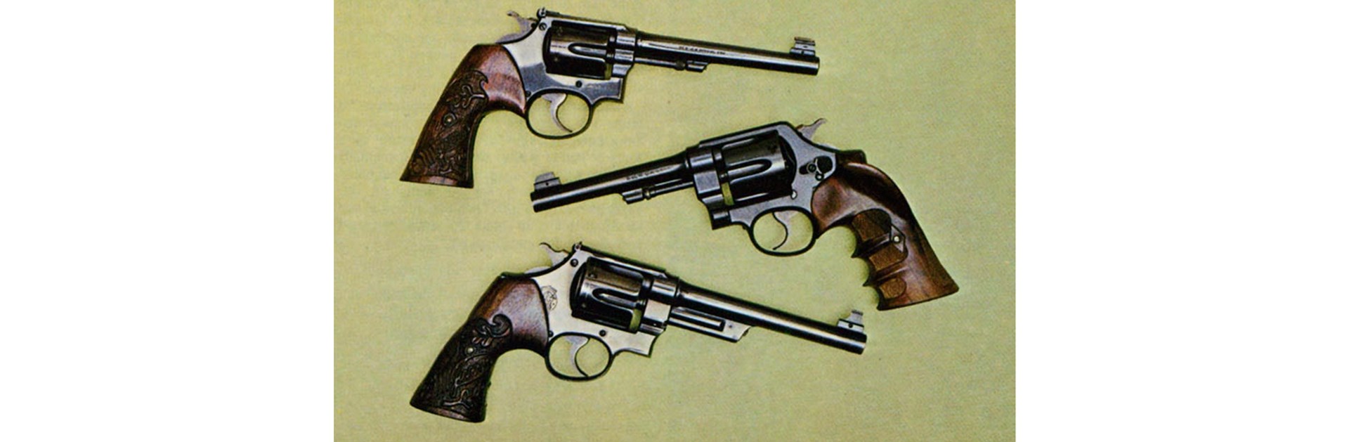 Two of these Smith & Wessons have grips carved with McGivern's name. They are (top to bottom) a K-38 with King front sight; a 1917-type .45 ACP and .44 Triple Lock.