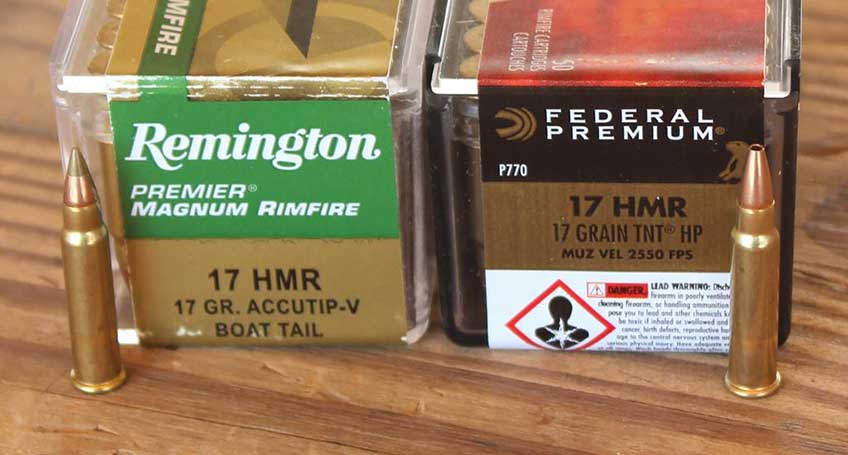 Two boxes of ammunition and two loose bullets in a row; Remington Accutip-v on left and Federal Premium TNT on right.