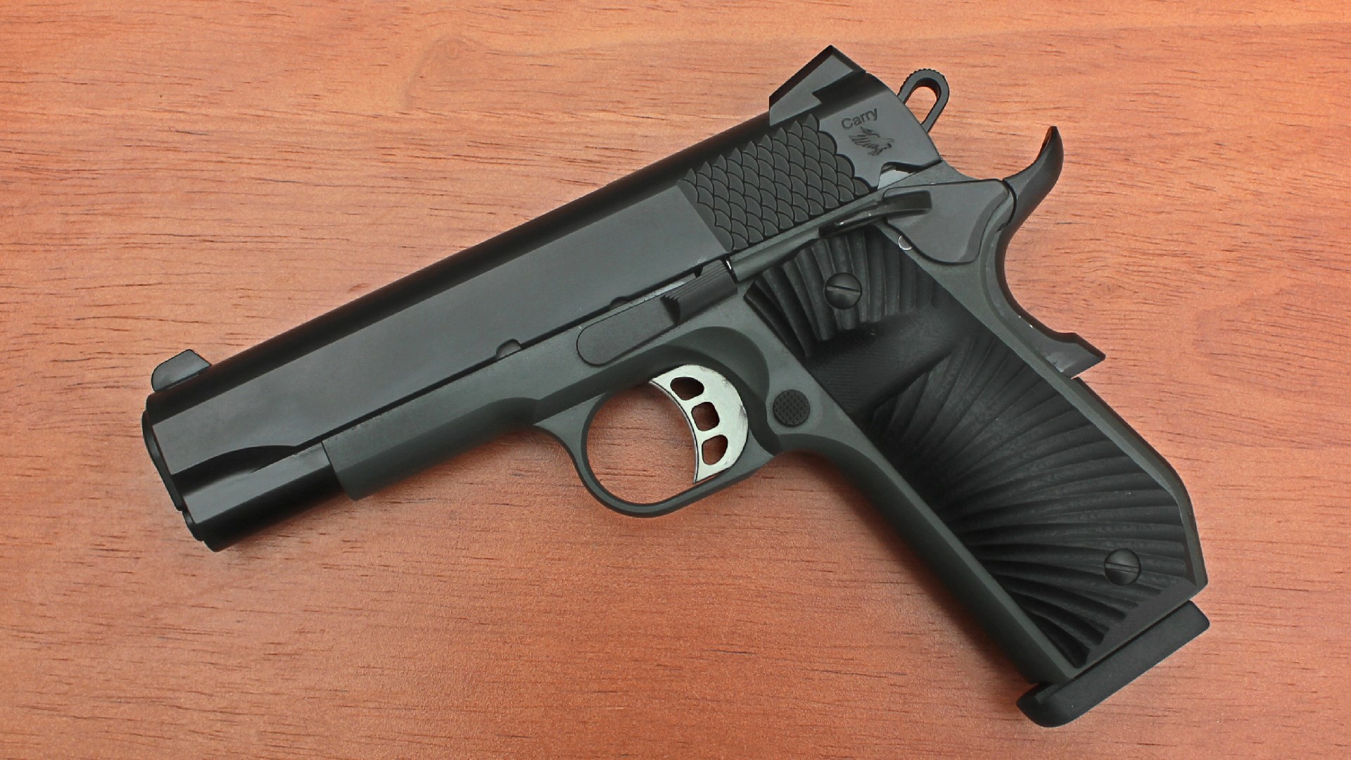 left-side view tisas stingray 1911 pistol 9 mm black gun on wood table