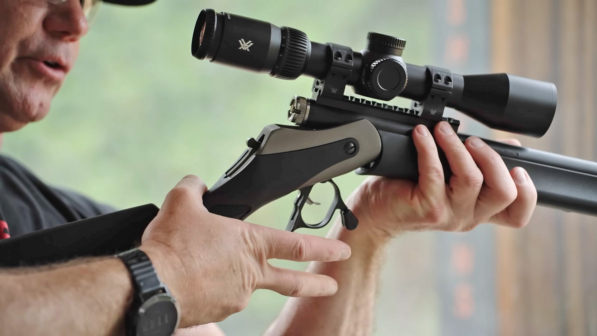A man using the opening lever on the Triumph in-line muzzleloader.
