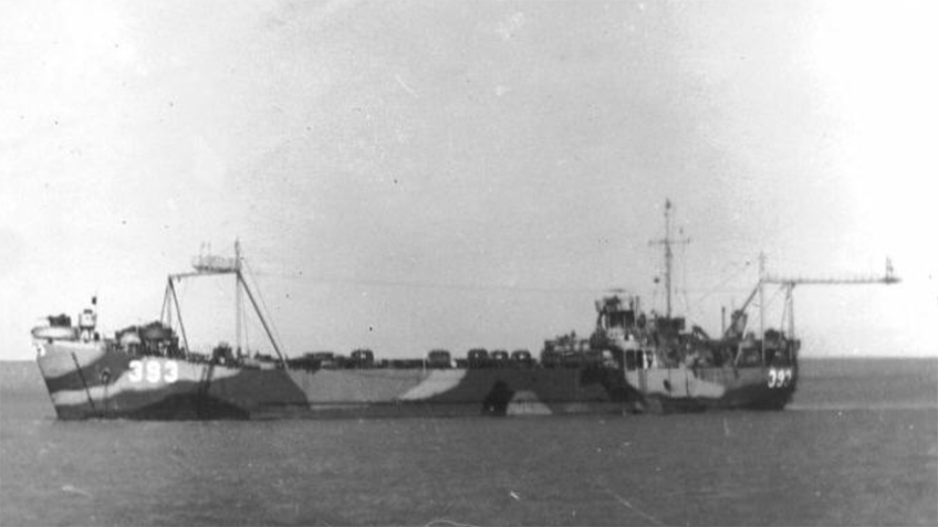 LST 393 as seen in 1945, prepared for the Pacific theater with tropical camouflage and the Broadie landing system installed.