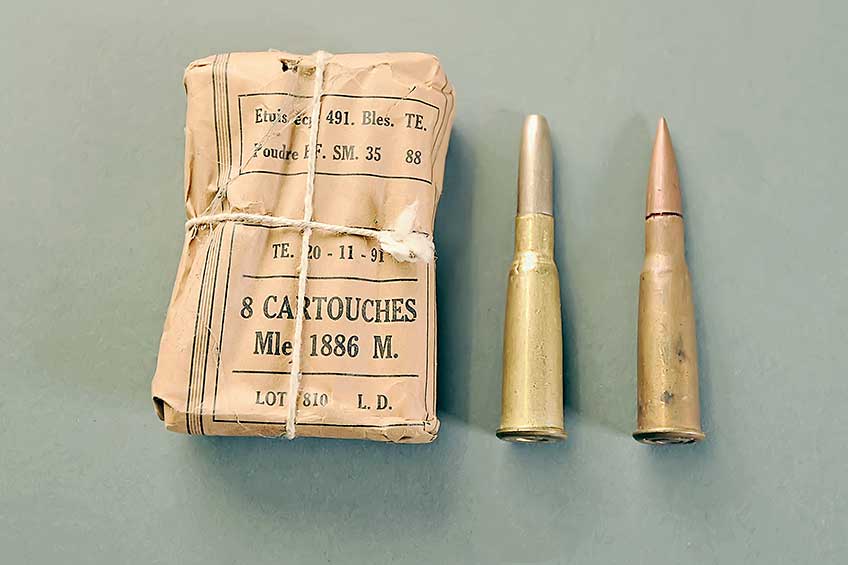 The Lebel’s 8x50R mm cartridge was the first smokeless-propellant load to be generally issued to a military force. Compared are: a paper packet containing eight rounds of Balle M, a single Balle M cartridge and a round of Balle D.