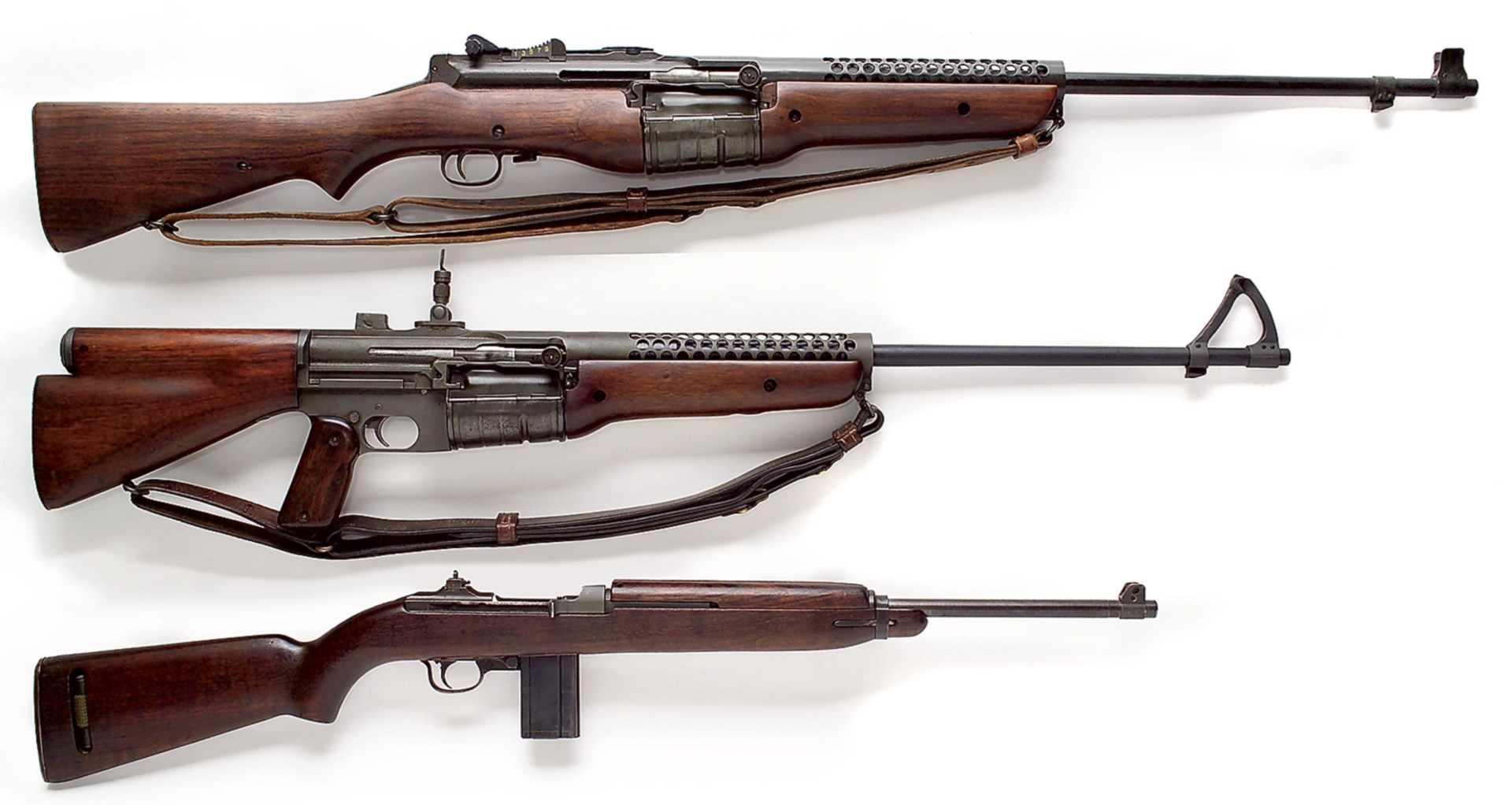 row stack of guns johnson auto m1 carbine three rifles carbines vintage world war ii