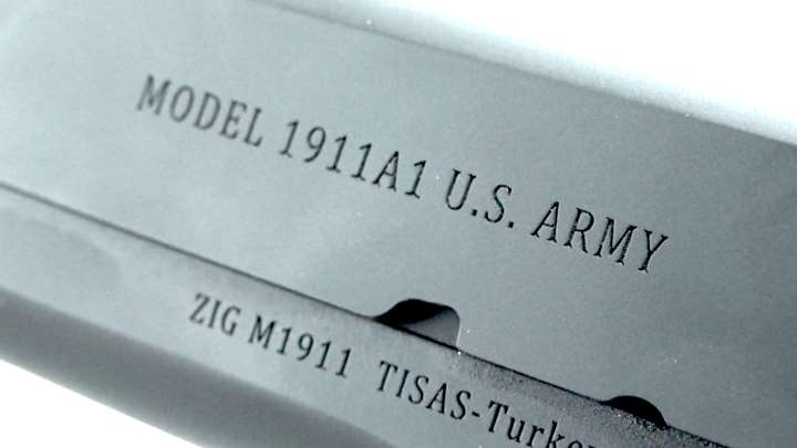 Stamping along the left side of a pistol slide communicating the make, model and manufacturer.