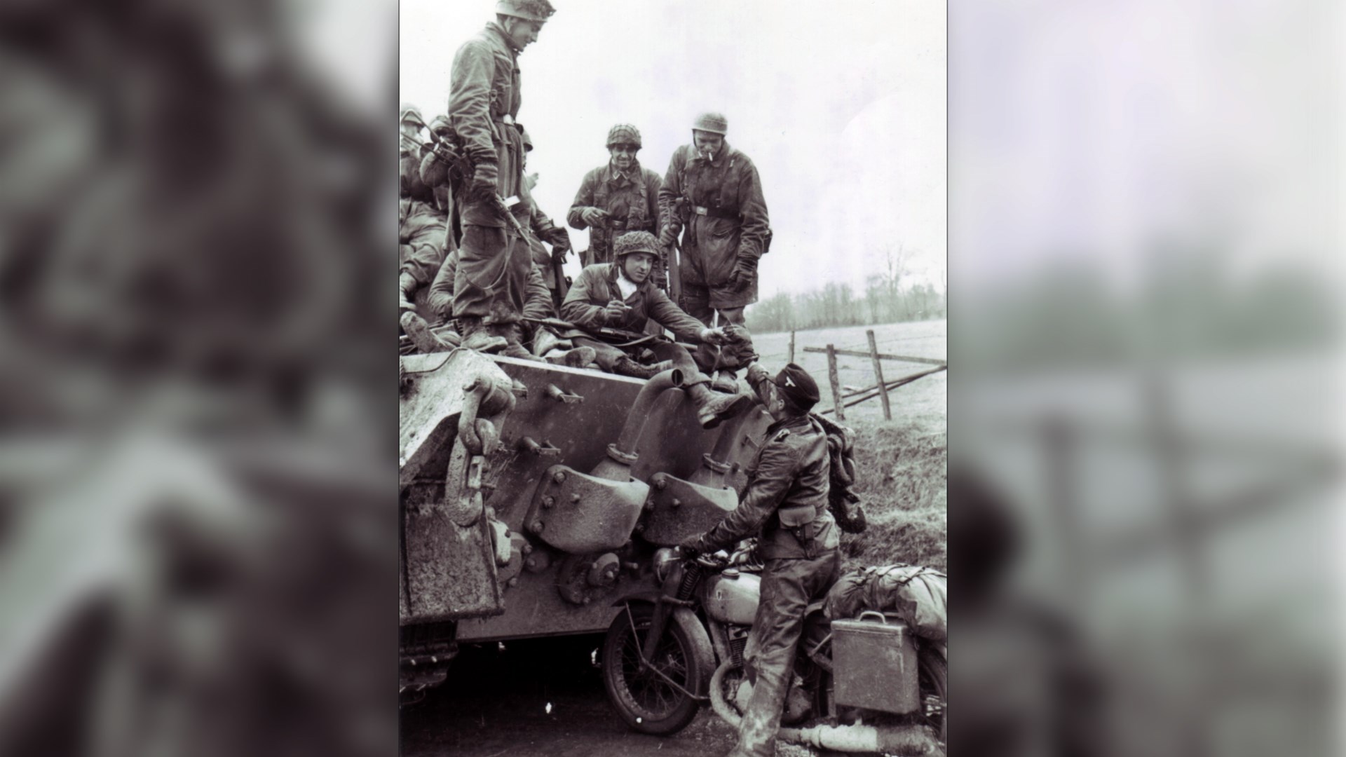 German paratrooper aboard a King Tiger tank during the Ardennes offensive.