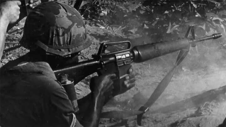 A Marine taking aim with his M16 rifle.