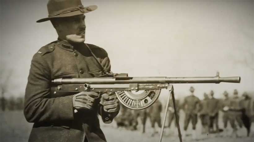 A soldier aiming the Chauchat from a hip-firing position.