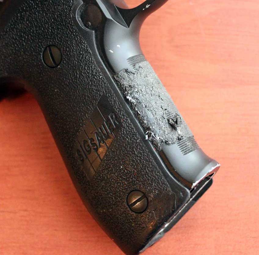 SIG Sauer P226 handgun grip stock frame black plastic metal closeup screw tape adhesive sticky