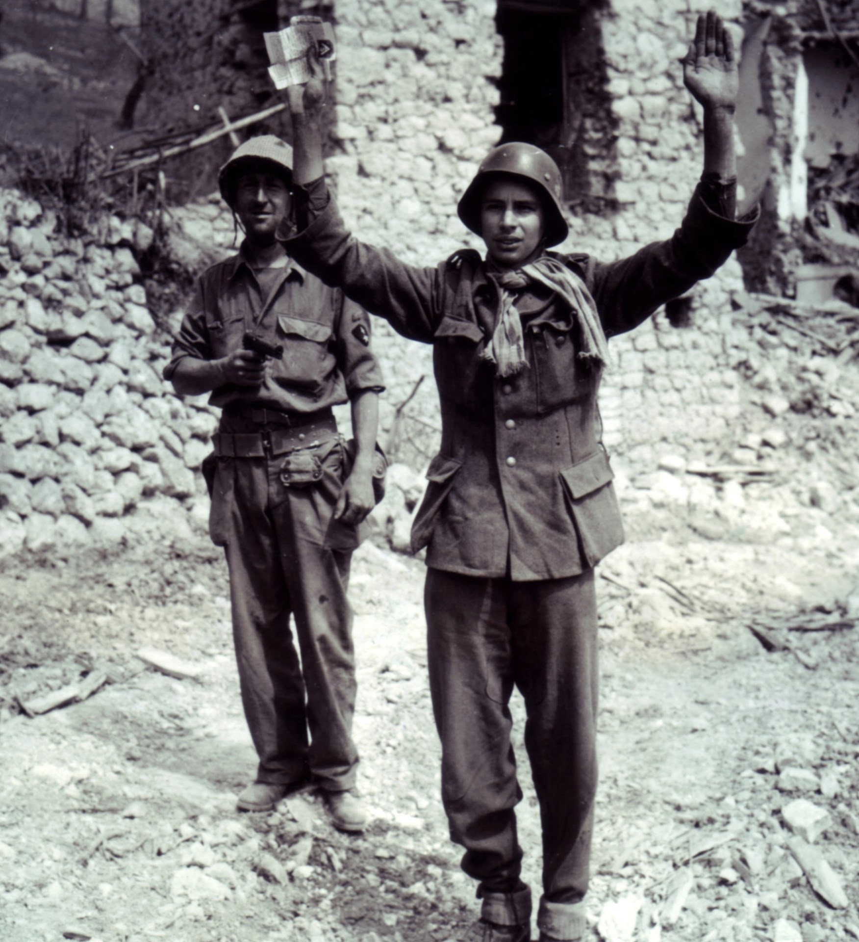 5)	M1911 pistol: Bringing in a prisoner at pistol-point, Castelforte, Italy during May 1944.