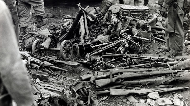 Captured weapons:  A haul of captured Communist weapons, including a bundle of Mosin-Nagant rifles and carbines with a Japanese Arisaka Type 99 rifle on top.