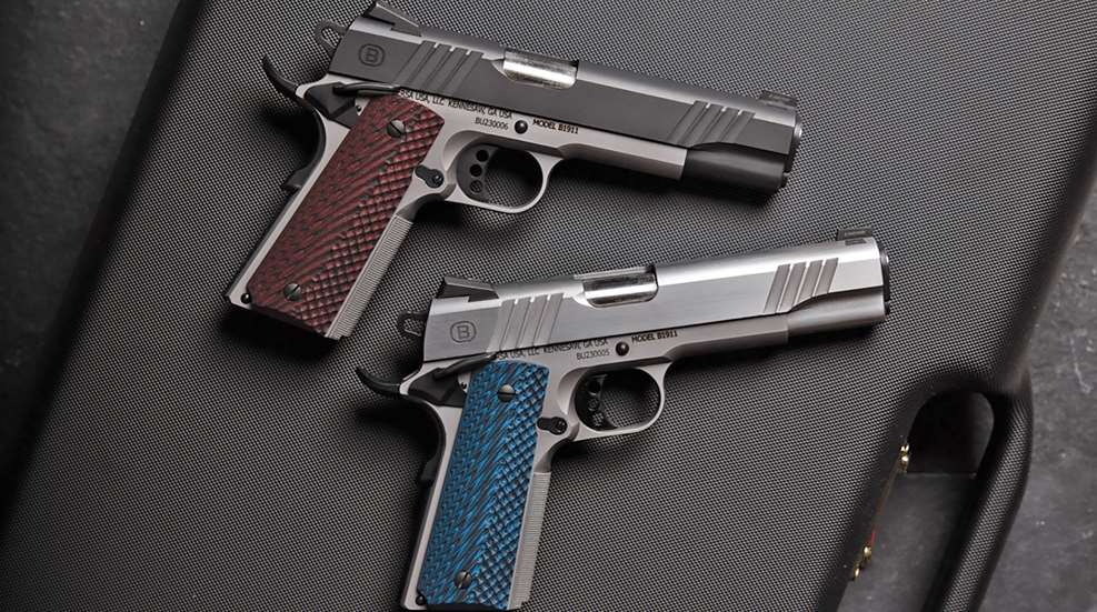 Two Bersa B1911 pistols sitting on a black gun case.