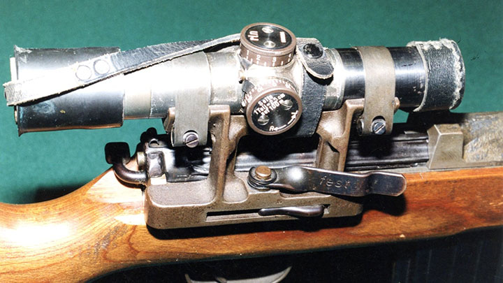 A close-up of the Zf.4 scope on a late-war G.43. The casting of the mount is clear as is the unusual sprung bands that were employed to retain the scope in its cradle. The thumb-latch lever was prone to snagging and could allow the scope to fall off.
