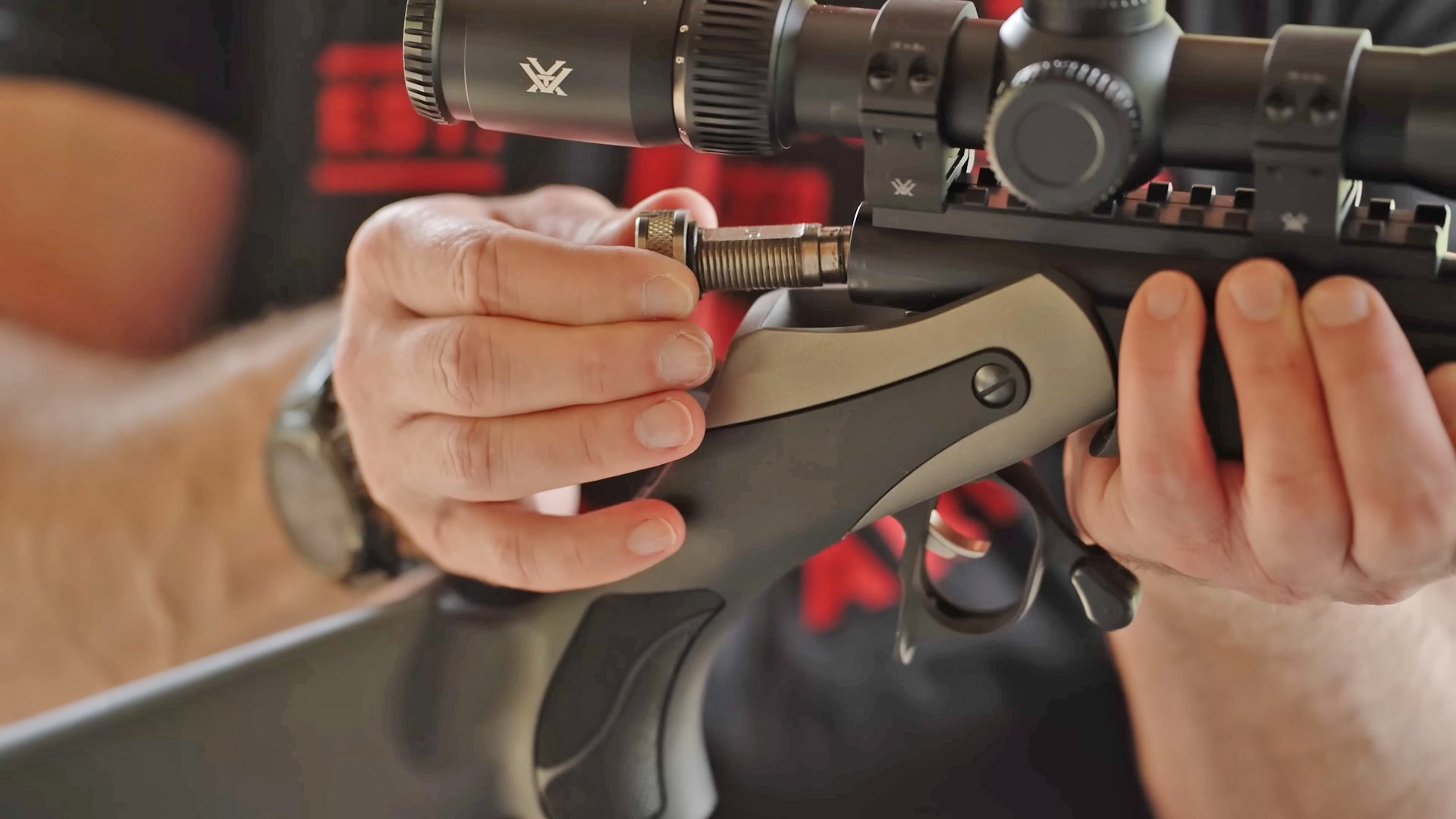 Man removing the breechplug from a Thompson/Center Arms Triumph muzzleloader.