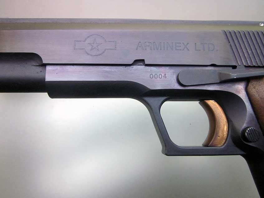 Closeup of the trigger and dust cover of the Arminex TriFire.