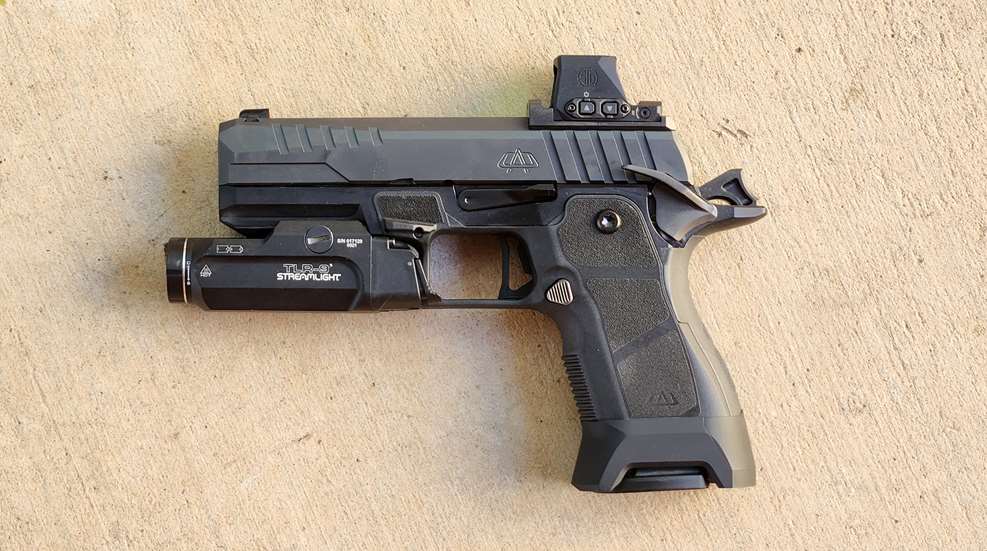OA Defense 2311 pistol left-side view on concrete shown with optic and light attached accessories black gun