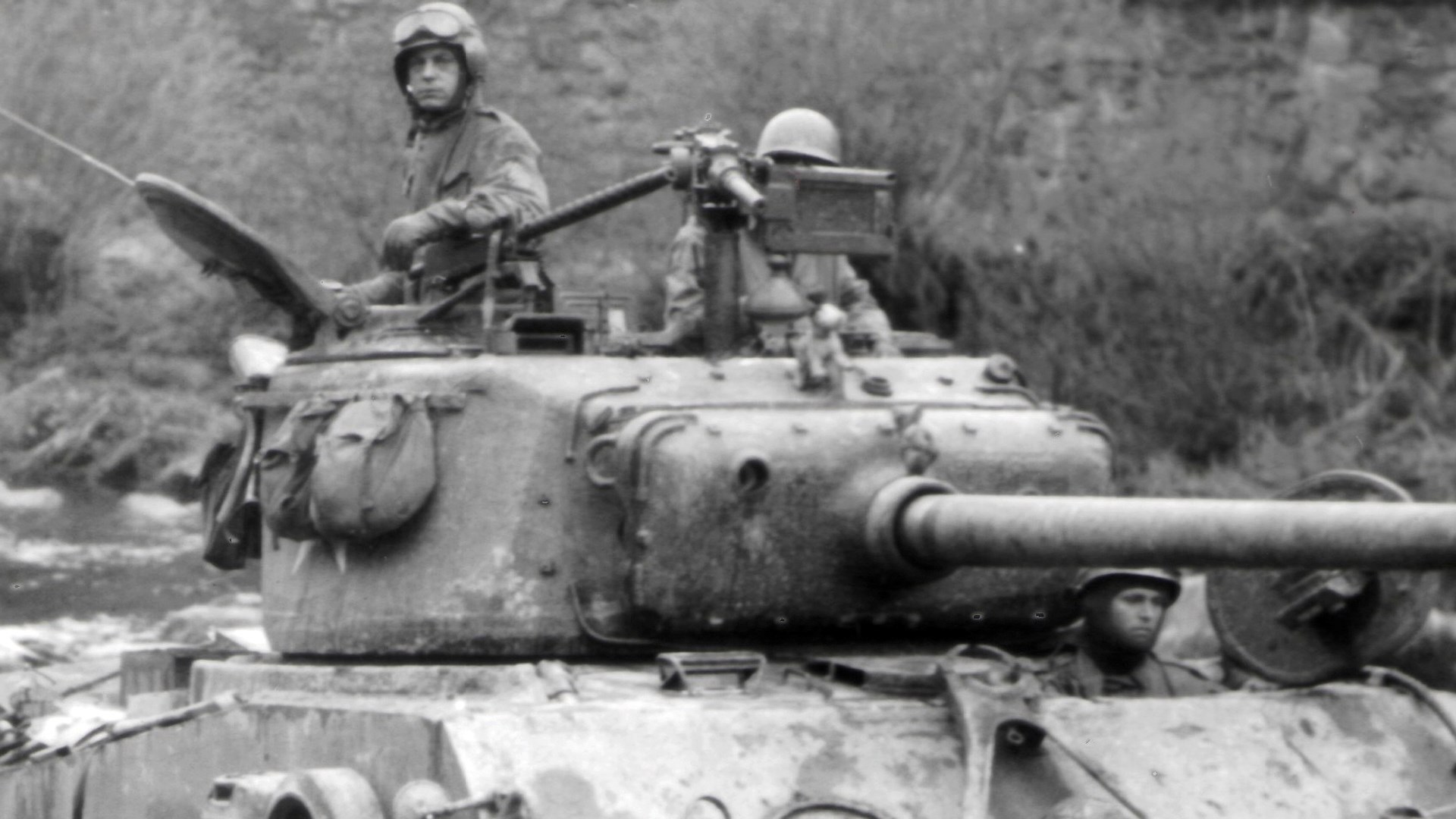 To help protect against German Panzerfaust/Panzerschreck AT weapons, many U.S. tankers added a Browning .30-cal. M1919 MG (this one on an infantry M2 tripod) for the commander to suppress the infantry AT teams.