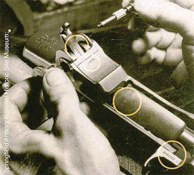 worker assembles an early gas trap M1 rifle