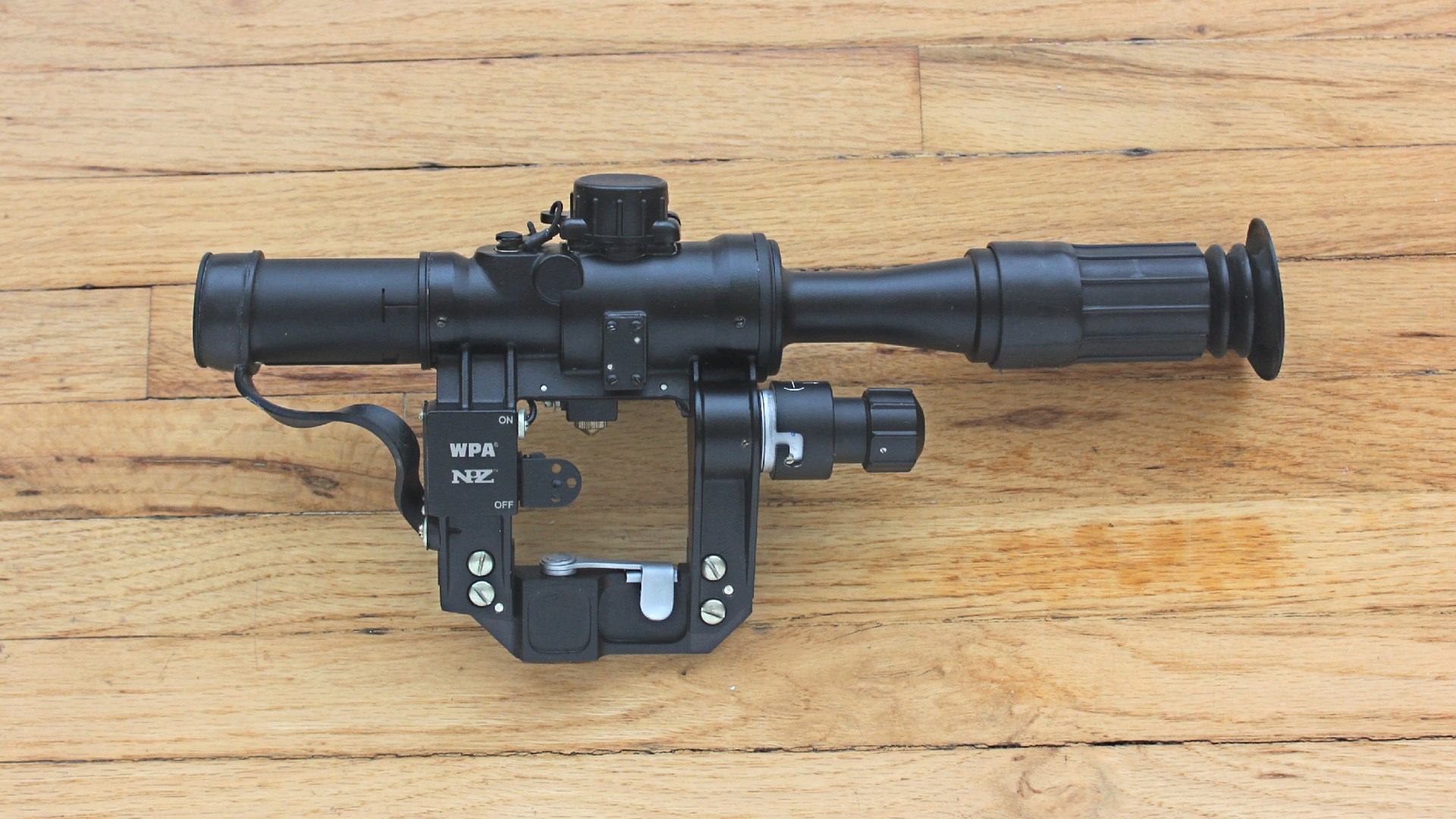 Century Arms PSL 54 riflescope left-side view on wood floor