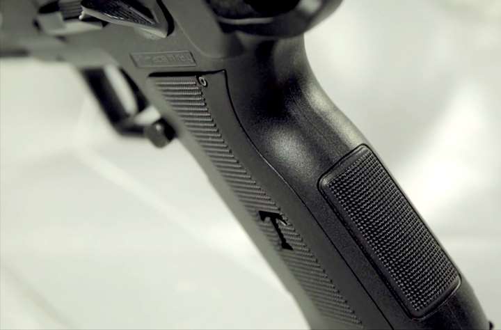 Close-up of EAA pistol grip highlighting texturing panels.