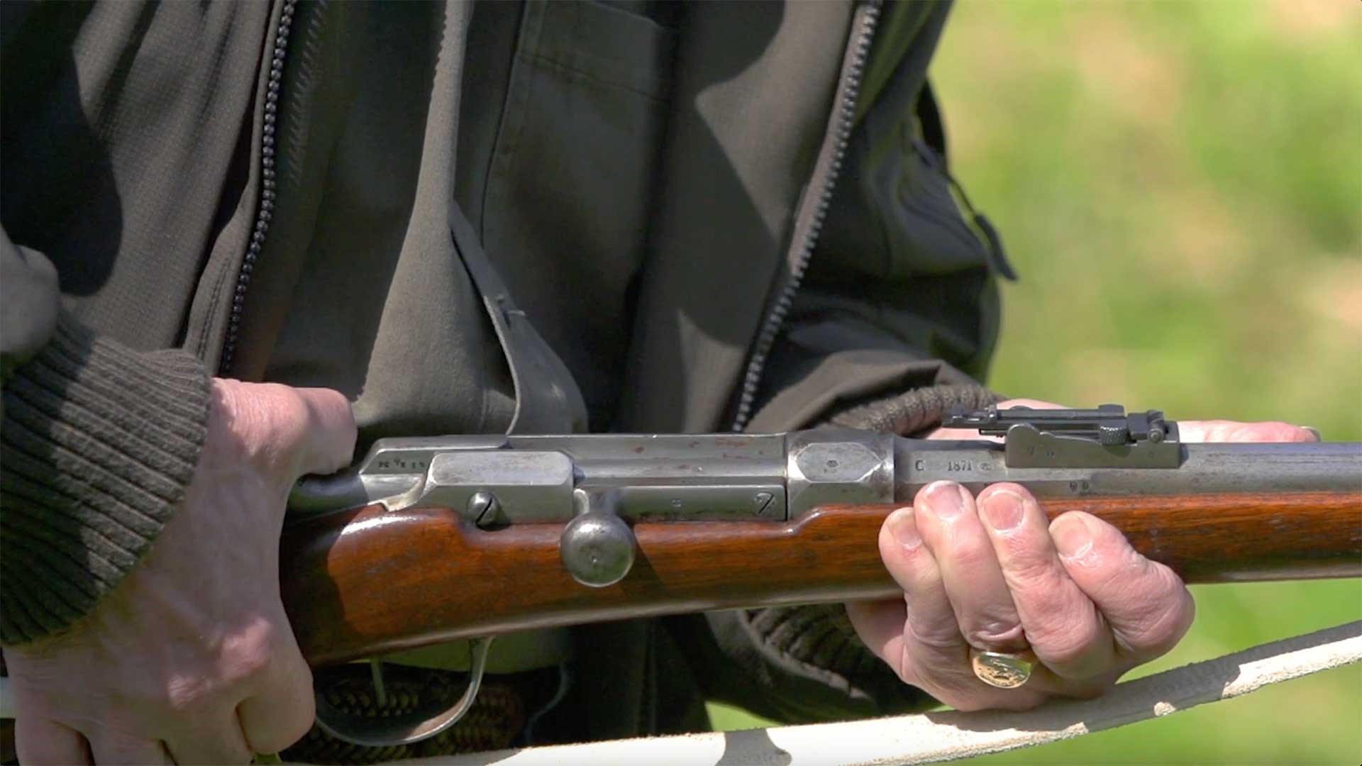 Man pulling back the cocking piece on a Model 1866 Chassepot rifle.