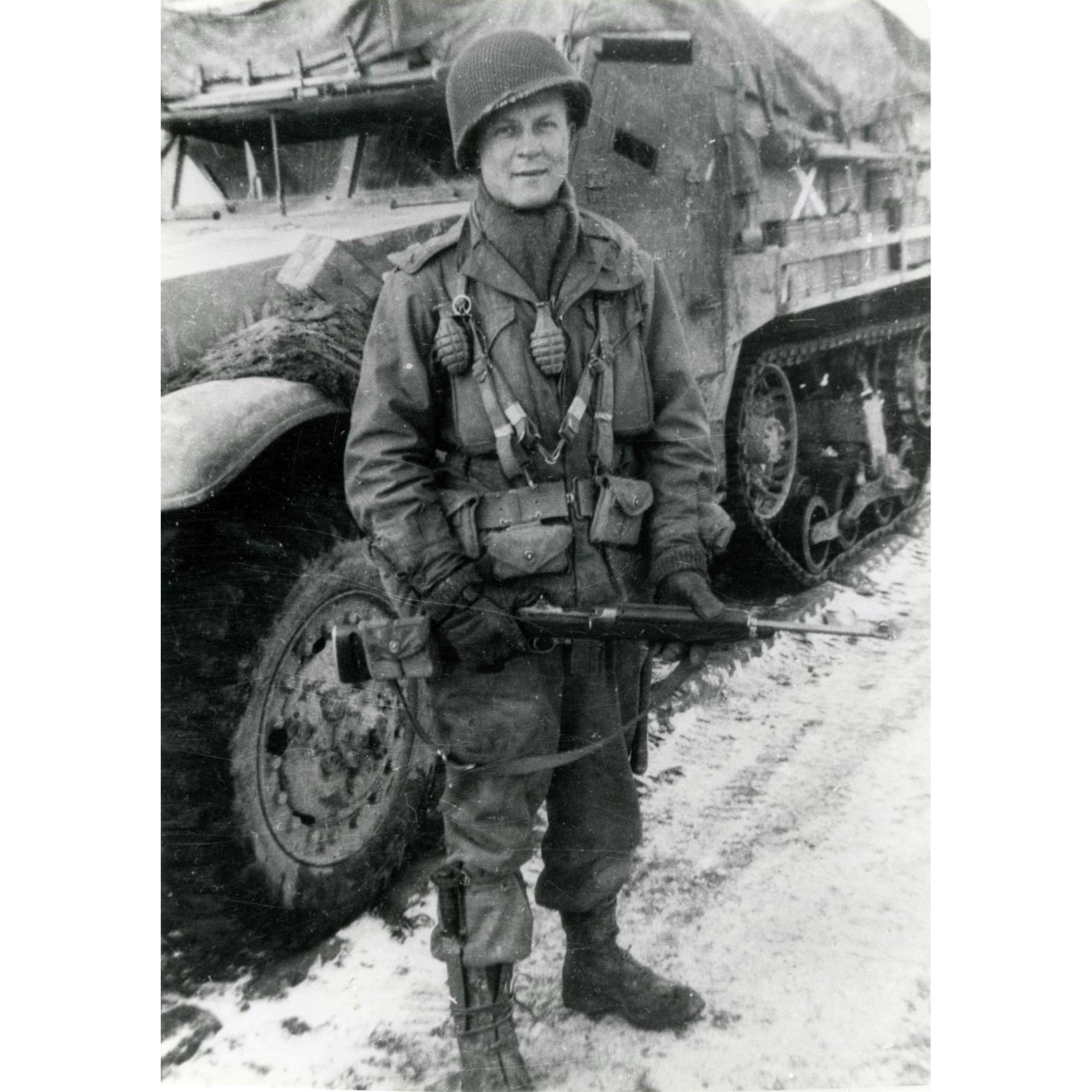 Armored infantry: An “armored GI” poses in front of M3 halftrack. He carries the handy M1 Carbine with a magazine pouch on the stock.
