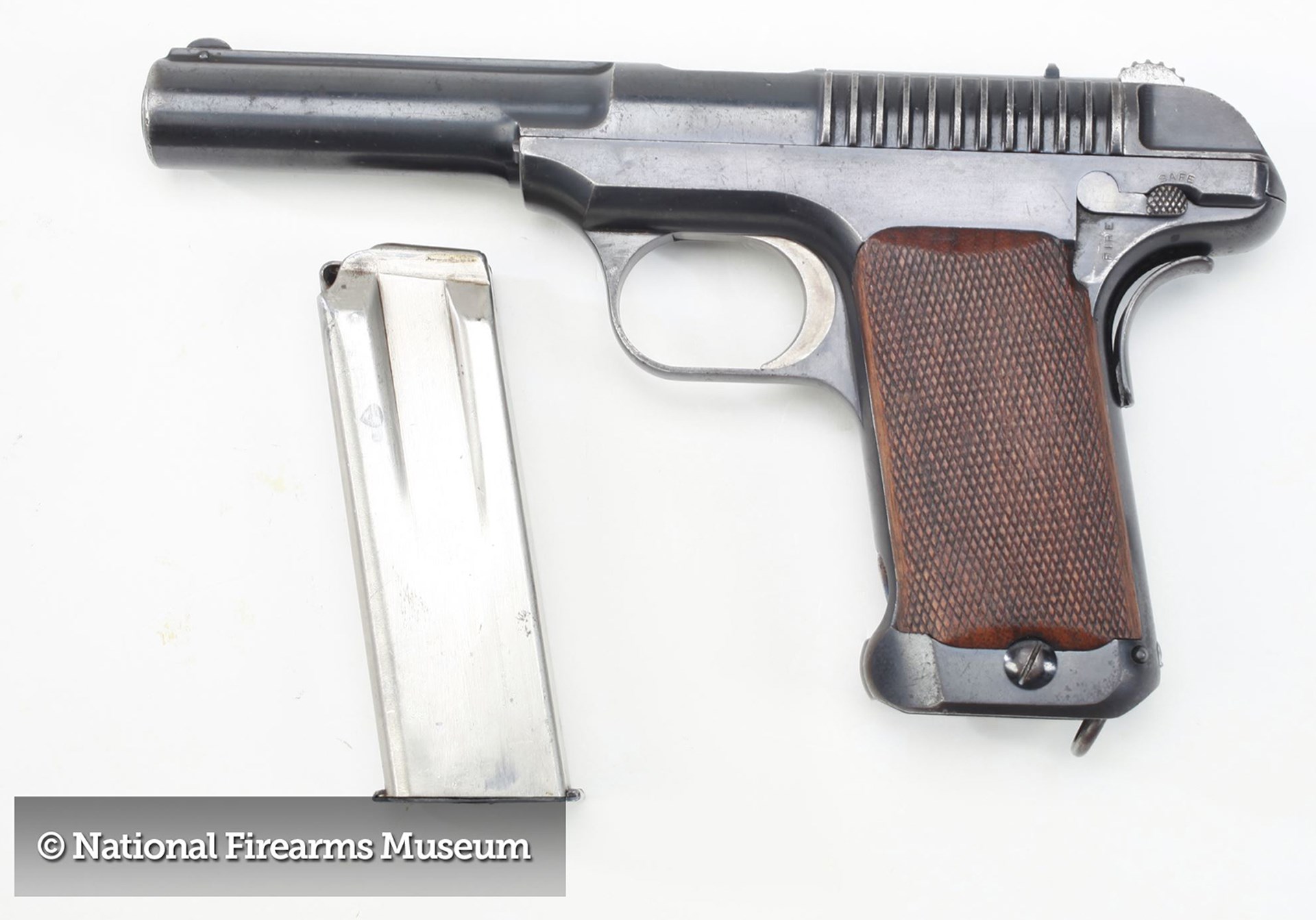 An original Savage trial pistol in .45 ACP left-side view gun metal magazine text on image noting copyright national firearms museum