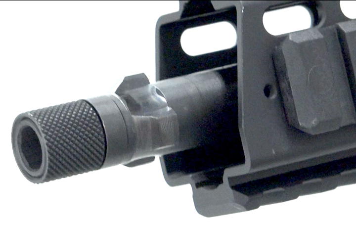 Muzzle and fore-end of GHM9 with tri-lug mount and knurled thread suppressor.
