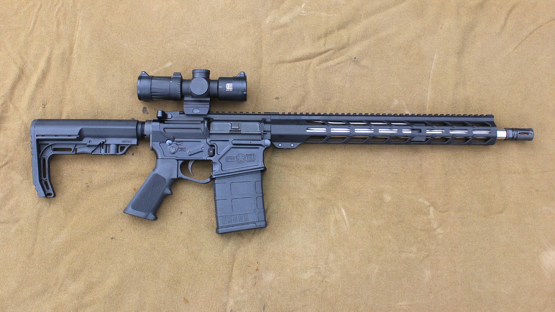 Right-side full-length view POF-USA LMR Base rifle .308 Winchester black gun stainless steel barrel shown with riflescope attached to upper receiver Picatinny rail on brown/tan cloth background