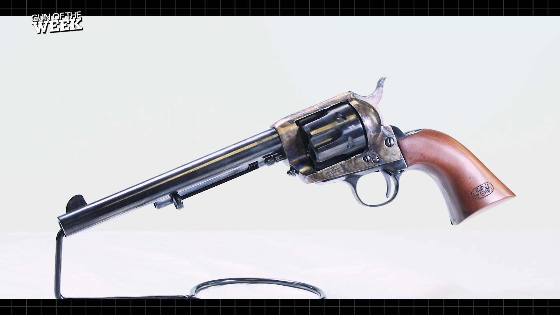 Cimarron Firearms Model P Henry Nettleton Single Action Army revolver left-side view on stand white background GUN OF THE WEEK text corner