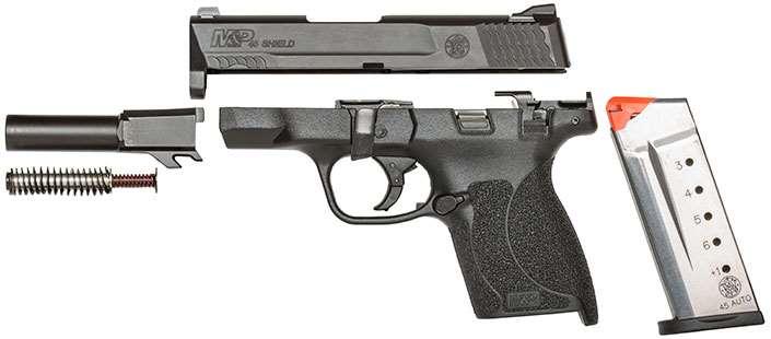 Smith &amp; Wesson black polymer pistol disassembled on white background.