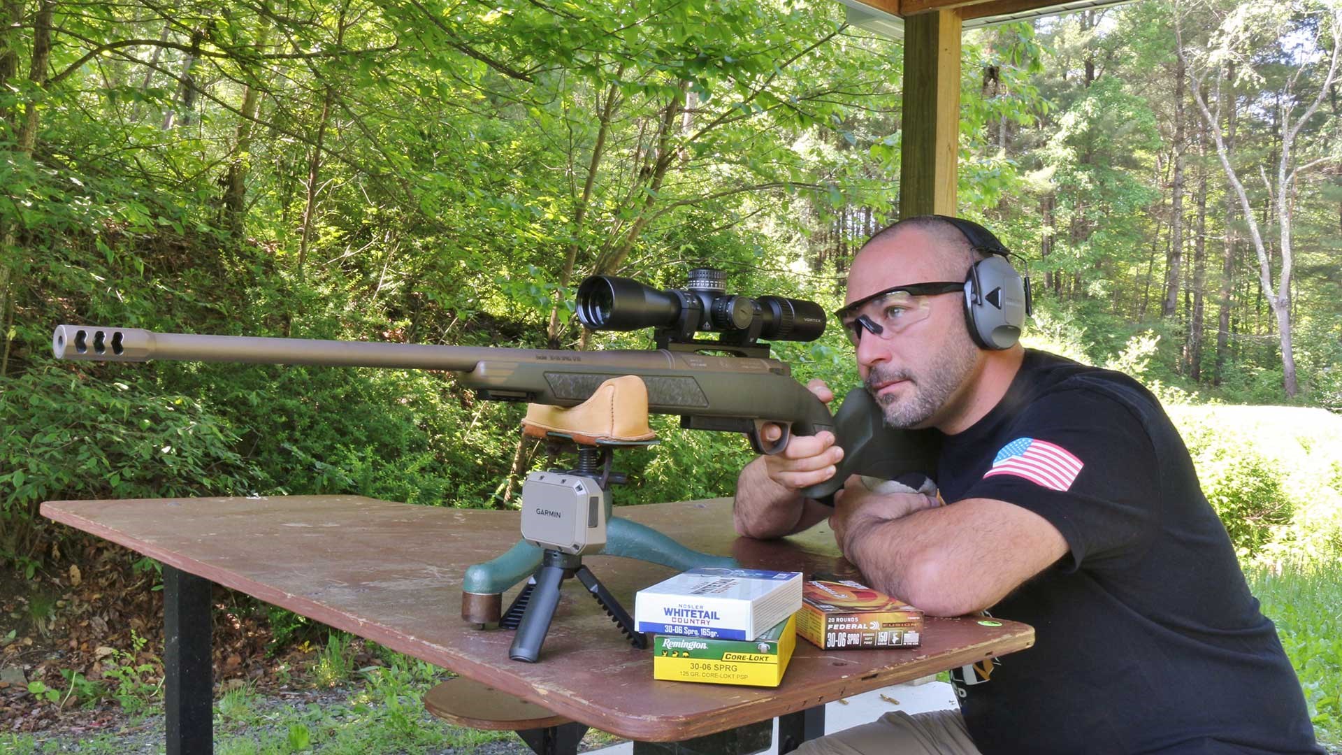Man at a shooting bench aiming the Christensen Arms Evoke bolt-action rifle.
