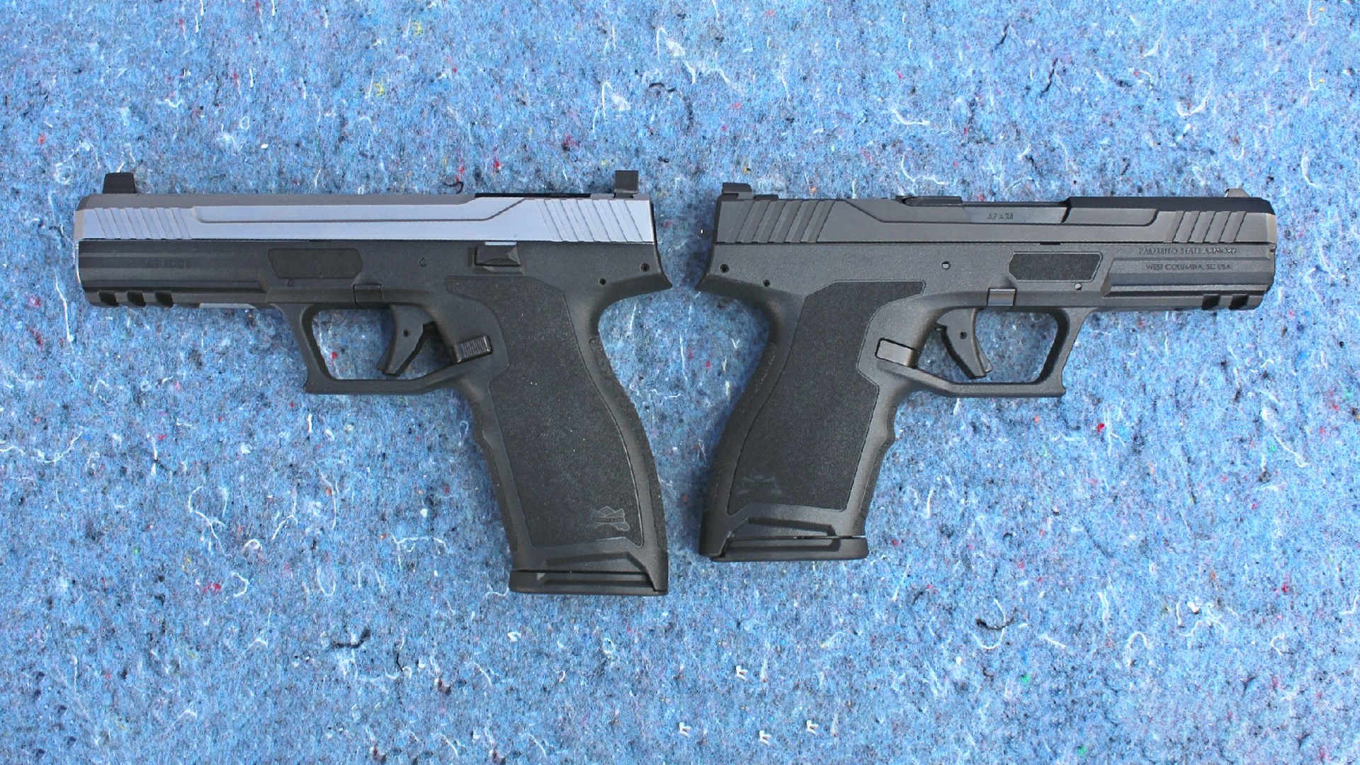 Palmetto State Armory 5.7 Rock pistols back to back full size on left with stainless steel slide and full black compact version on right shown on blue chipped stone
