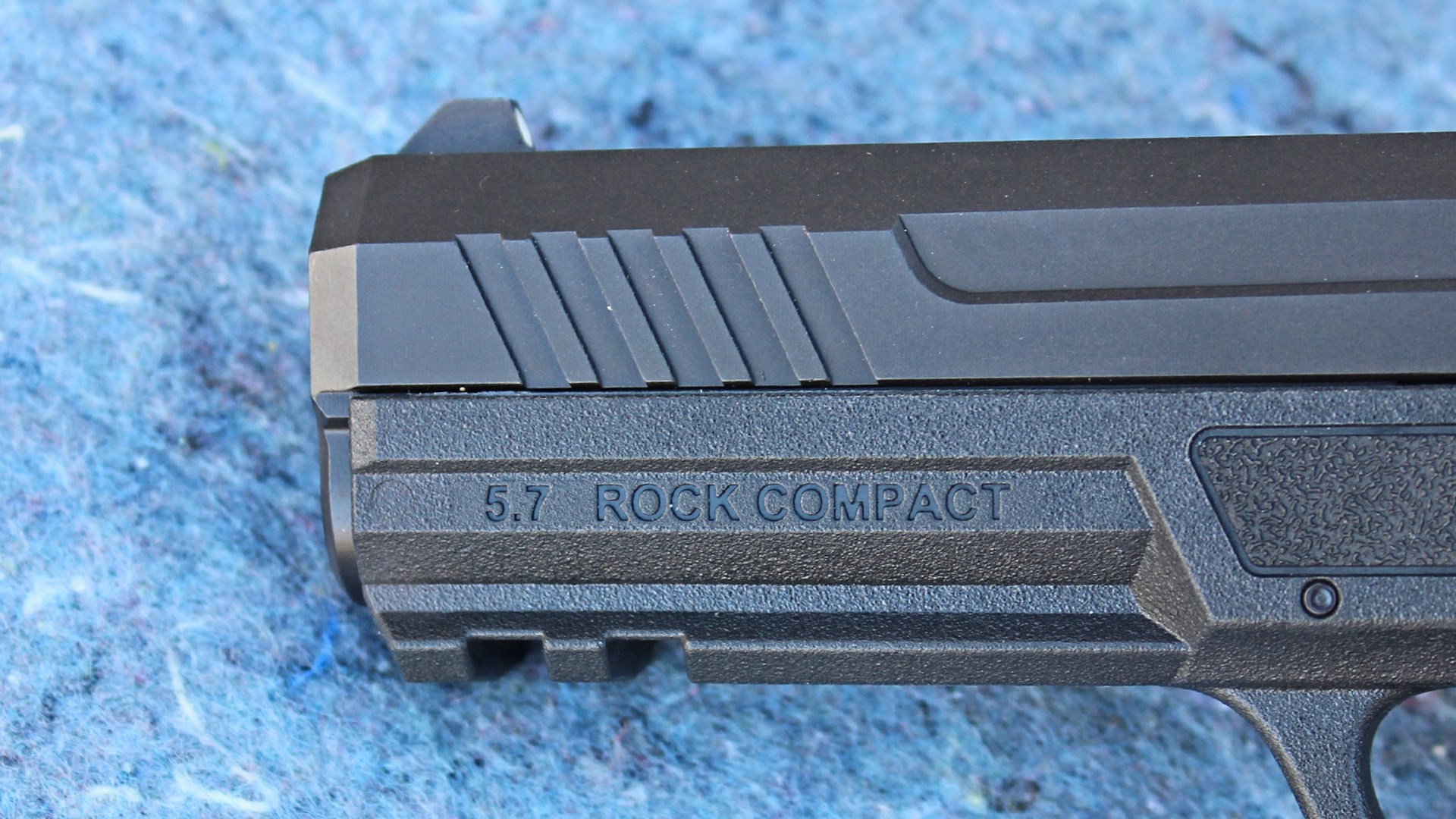 Palmetto State Armory 5.7 Rock Compact pistol muzzle slide dustcover illustrating stamp above accessory rail