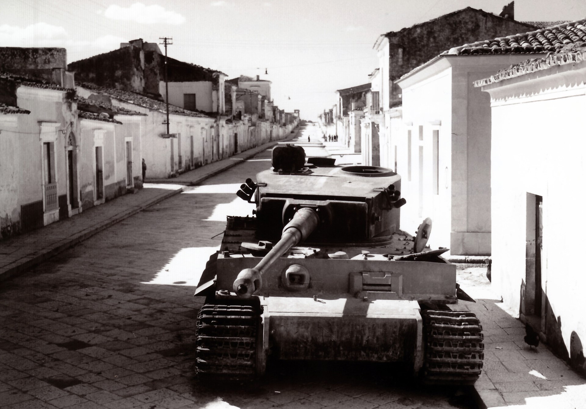 15)	The massive German Pzkw VI Tiger I, knocked out on the streets of Biscari, Sicily.  Sixteen of these 60-ton tanks were lost during the campaign on Sicily.  NARA